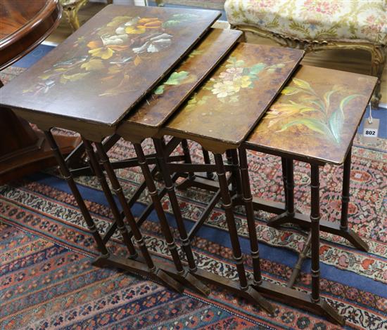 A nest of lacquered quartetto tables with painted floral decoration 56cm